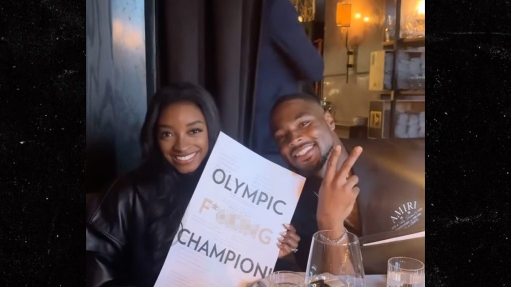 simone-biles-poses-with-‘olympic-f***ing-champion’-menu